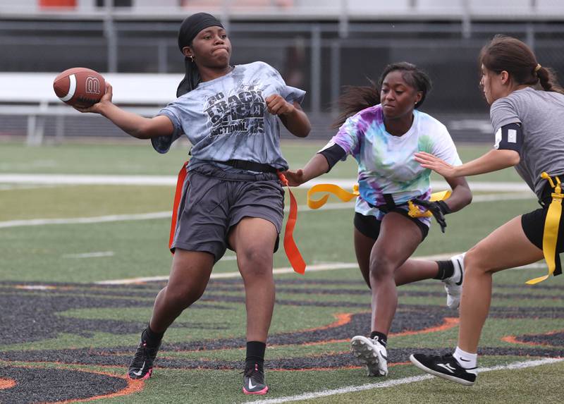 DeKalb’s Angela Gary throws a pass just before her flag is pulled Wednesday, Aug. 20, 2025, during the first practice of the DeKalb High School flag football team. The squad is preparing for their inaugural season.