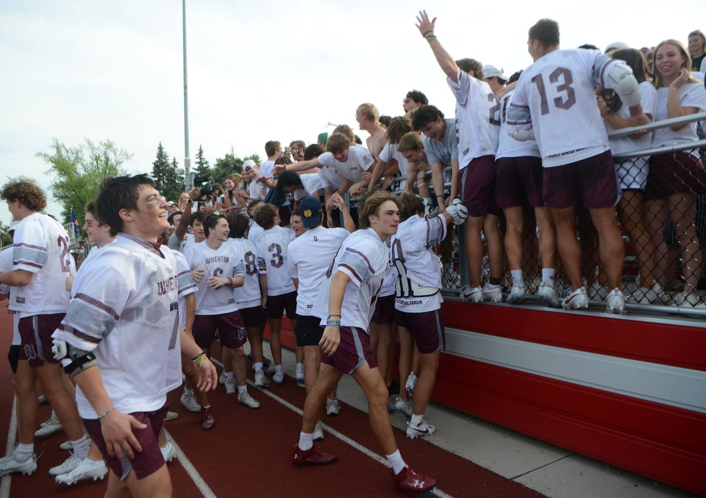 Wheaton Academy players celebrate with fans after winning  the boys state lacrosse championship in Hinsdale Saturday, June 3, 2023.