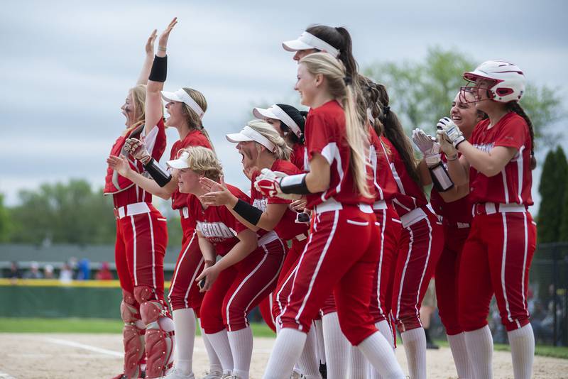 The Oregon Hawks softball teams waits at home plate to celebrate a home run by teammate Lena Trampel Friday, May 20, 2022.