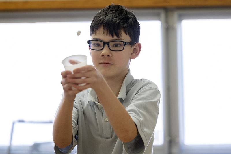 St. Anne’s fifth grader Alex Brown looks to catch a marshmallow in a cup during a game at the school Tuesday, Jan. 28, 2025.