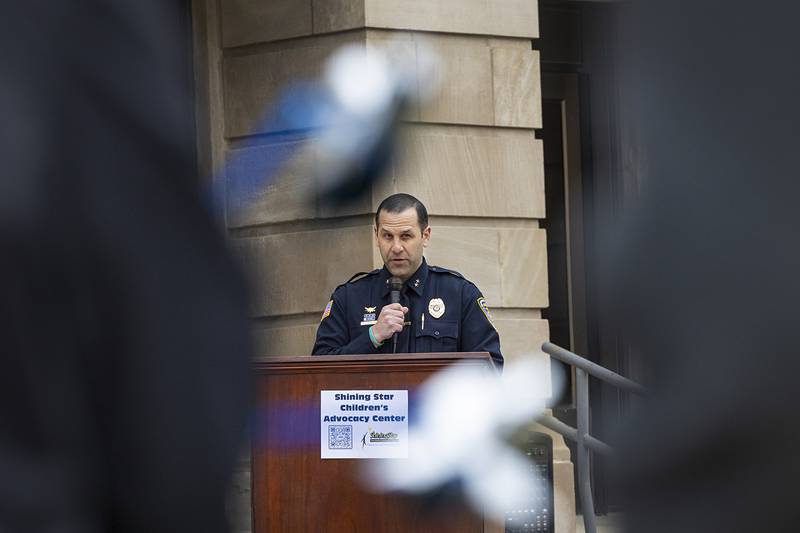 Dixon Deputy Police Chief Aaron Simonton speaks to a crowd Friday, April 10, 2026, during a Hands Around the Courthouse event hosted by Shining Star Children’s Advocacy Center to raise awareness of child abuse.