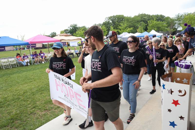Members of Team Pearce embark on the team lap during the Relay for Life of Kankakee County on June 14, 2025, at The Grove in Bourbonnais.