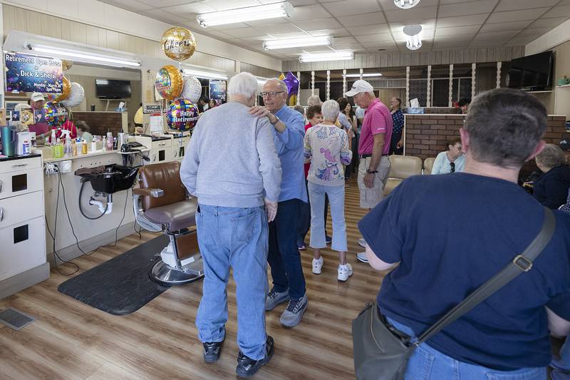Dick Dir greets friends, family and well-wishers Monday, March 30, 2026, during an open house at Bill and Dick’s Barbershop in Dixon. After 61 years, Dir is hanging up his scissors.