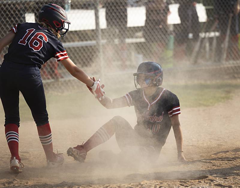 West Central’s Addie Seitz is helped up by teammate Bailie Ferguson after being tagged out at home against Morrison on Wednesday, May 24, 2023 during their Class 1A sectional semifinal at St. Bede Academy.