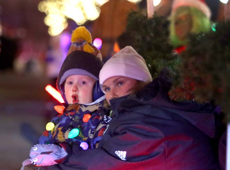 Maggie Mueller of Crystal Lake watches with her nephew Zach Kratenstein, 5, during the Festival of Lights Holiday Parade in downtown Crystal Lake on Fariday, Nov. 29, 2024.