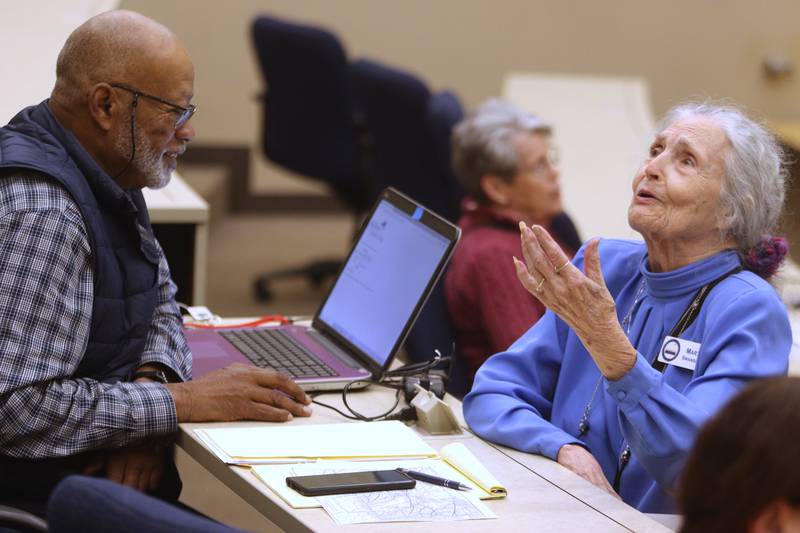Marti Swanson, right, of Ringwood visits with Jerry Johnson of Cary during a meeting of the McHenry County Illinois Genealogical Society on Thursday, March, 9, at McHenry County College. Thursday was the group’s first in-person meeting since before the pandemic.