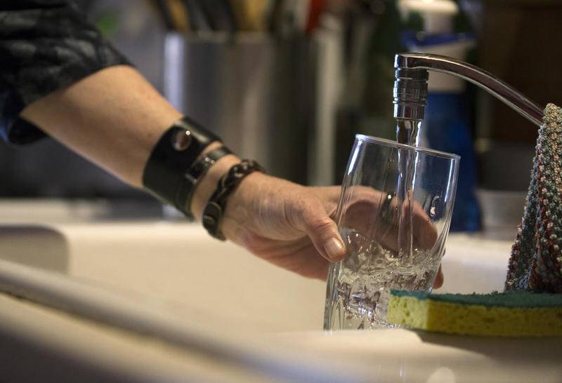 Debbie Mahler pours a glass of water from the kitchen sink of her home Thursday in Lake in the Hills.