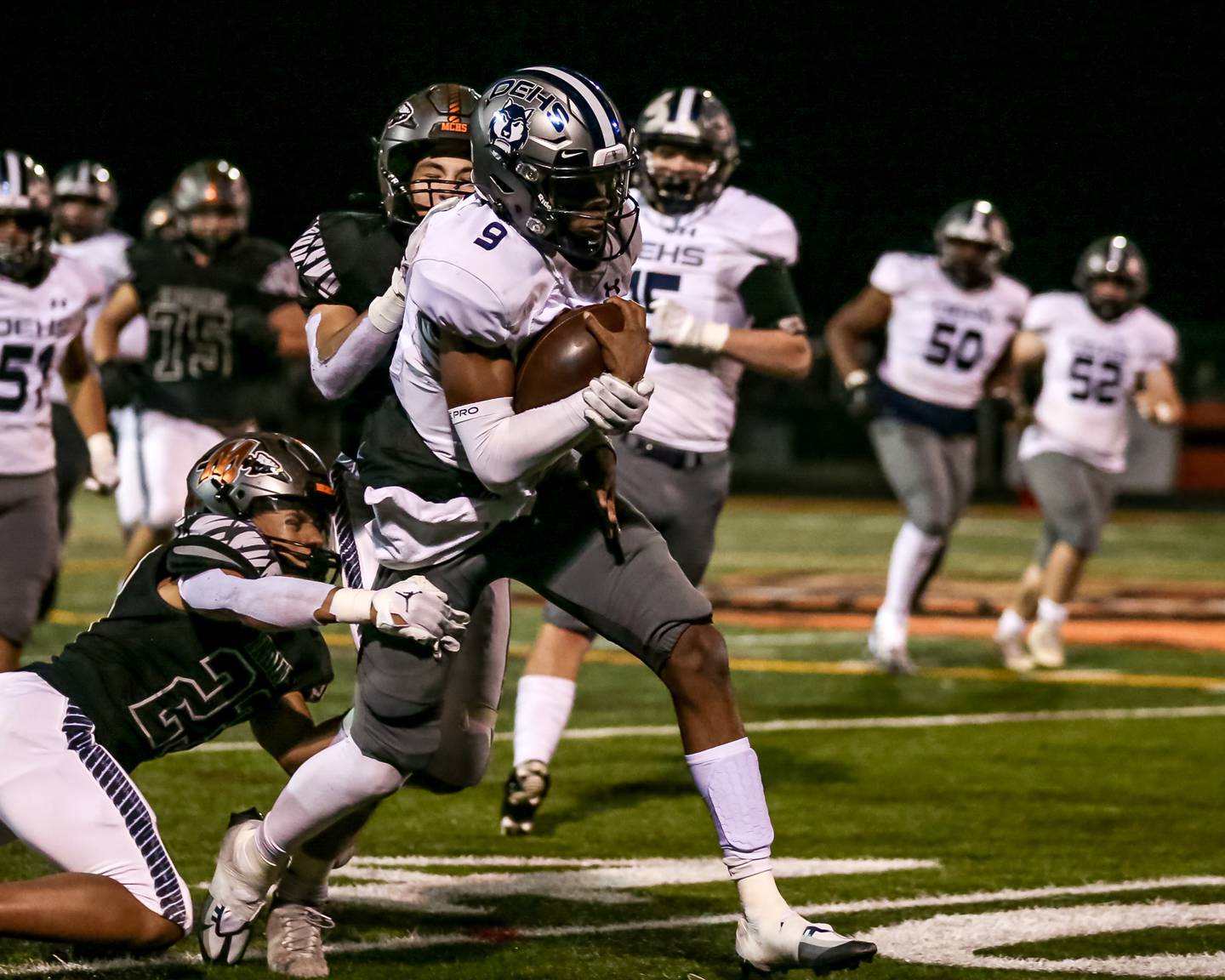 Oswego East's Robert Tyre Jones III (9) fights for tough yards during varsity football game between Oswego East at Minooka.  Sept 30, 2022