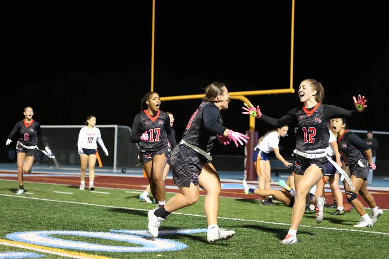Yorkville's Kayla Kersting, center, runs to celebrate with Annabel West as the Foxes secured a 2-1 overtime victory over Oswego in the IHSA Kankakee Regional championship game on Thursday, Oct. 9, 2025.