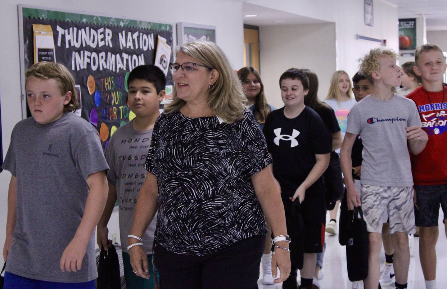 Janell Hartman accompanies her sixth-grade students through the hallways during a bell-change on Wednesday morning at West Carroll Middle School in Mount Carroll. It was the first day of school.