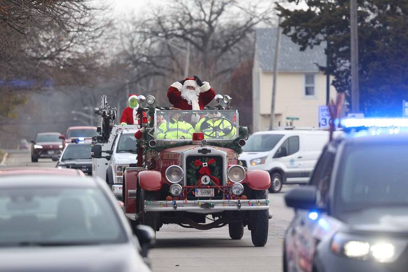 Santa rides atop a vintage fire truck through Joliet before he heads off to the North Pole for the annual Santa Send-Off on Saturday, Dec. 14, 2024 in Joliet.