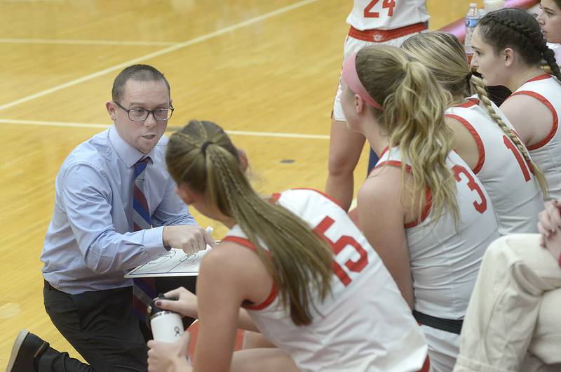 Ottawa Lady Pirates Head Coach Brent Moore goes over stodgy during a times out against Kaneland in the 3rd period Friday at Ottawa.