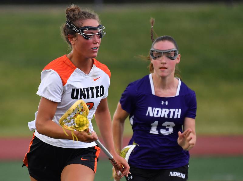 Crystal Lake’s Fiona Lemke races with the ball as Downers Grove North’s Finley Paul (13) chases during the Benet Supersectional game on June 3, 2025 at College of DuPage in Glen Ellyn.