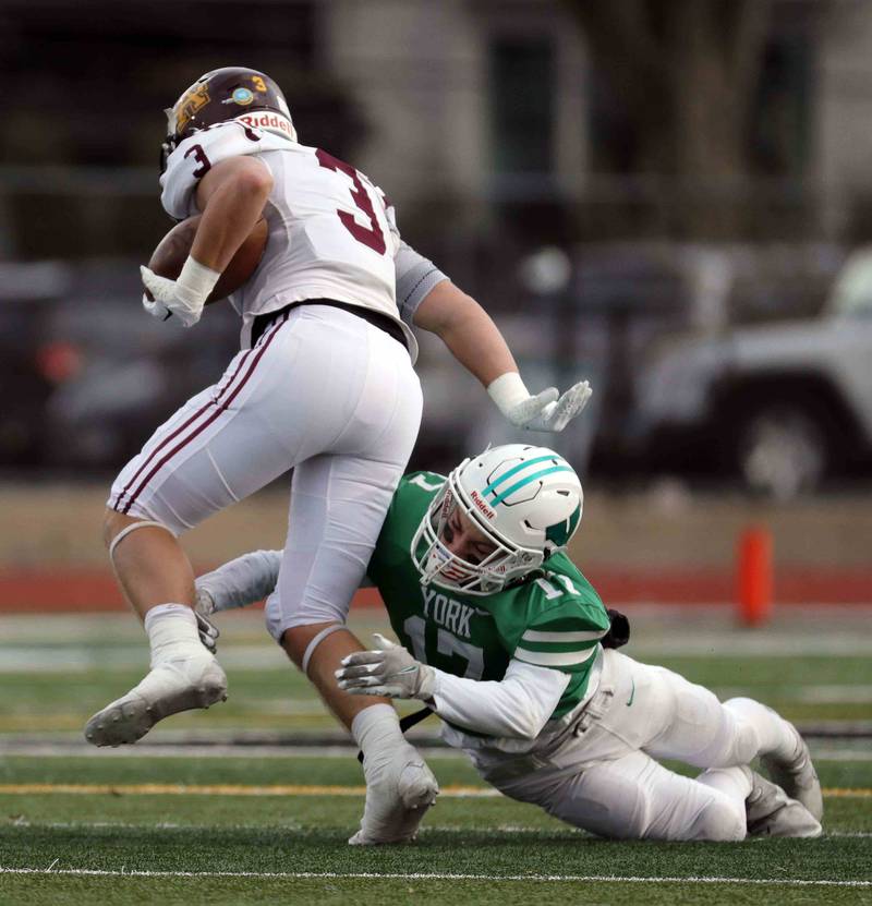 York’s Connor Dorner (17) with a shoestring tackle on Loyola's Quinn Foley (3) during the IHSA Class 8A semifinal football game Saturday November 19, 2022 in Elmhurst.