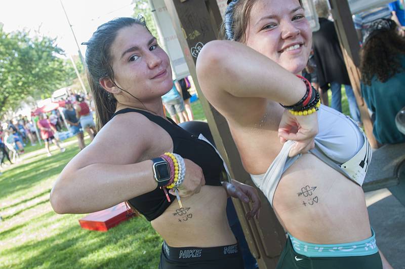 Sisters Grace (left) and Brooke Garcia of Huntley show off their matching tattoos after finishing the Reagan Run Saturday, July 2, 2022.