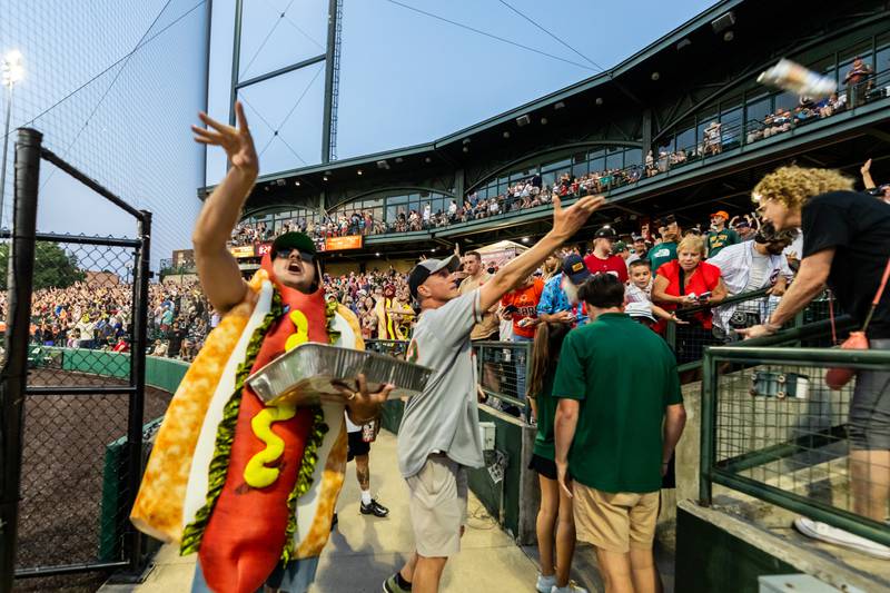 Slammers staff members and representatives from Pabst throw hot dogs to fans following the Wiener Drop World Record Attempt, sponsored by Pabst Light, at Duly Heath and Care Field on July 22, 2025.