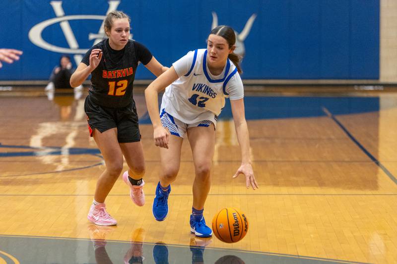 Geneva's Adelyn Estabrook dribbles past Batavia's Marian Schwab on Friday, Dec.19,2025 in Geneva.