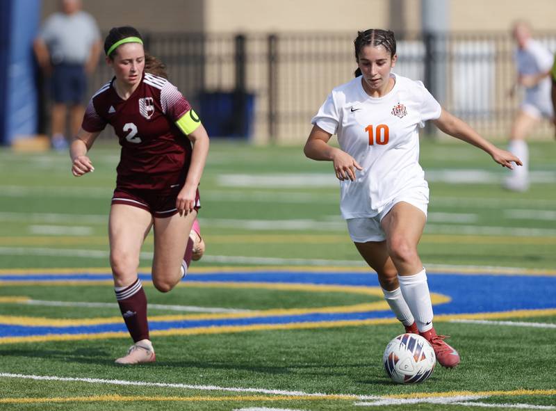 Crystal Lake Central's Addison Schaffer (10) tries to keep the ball away from St. Ignatius' Quinn Urquhart (2) during the 2A girl's varsity supersectional soccer match between Crystal Lake South and St. Ignatius high schools on Tuesday, June 3, 2025 in Chicago.