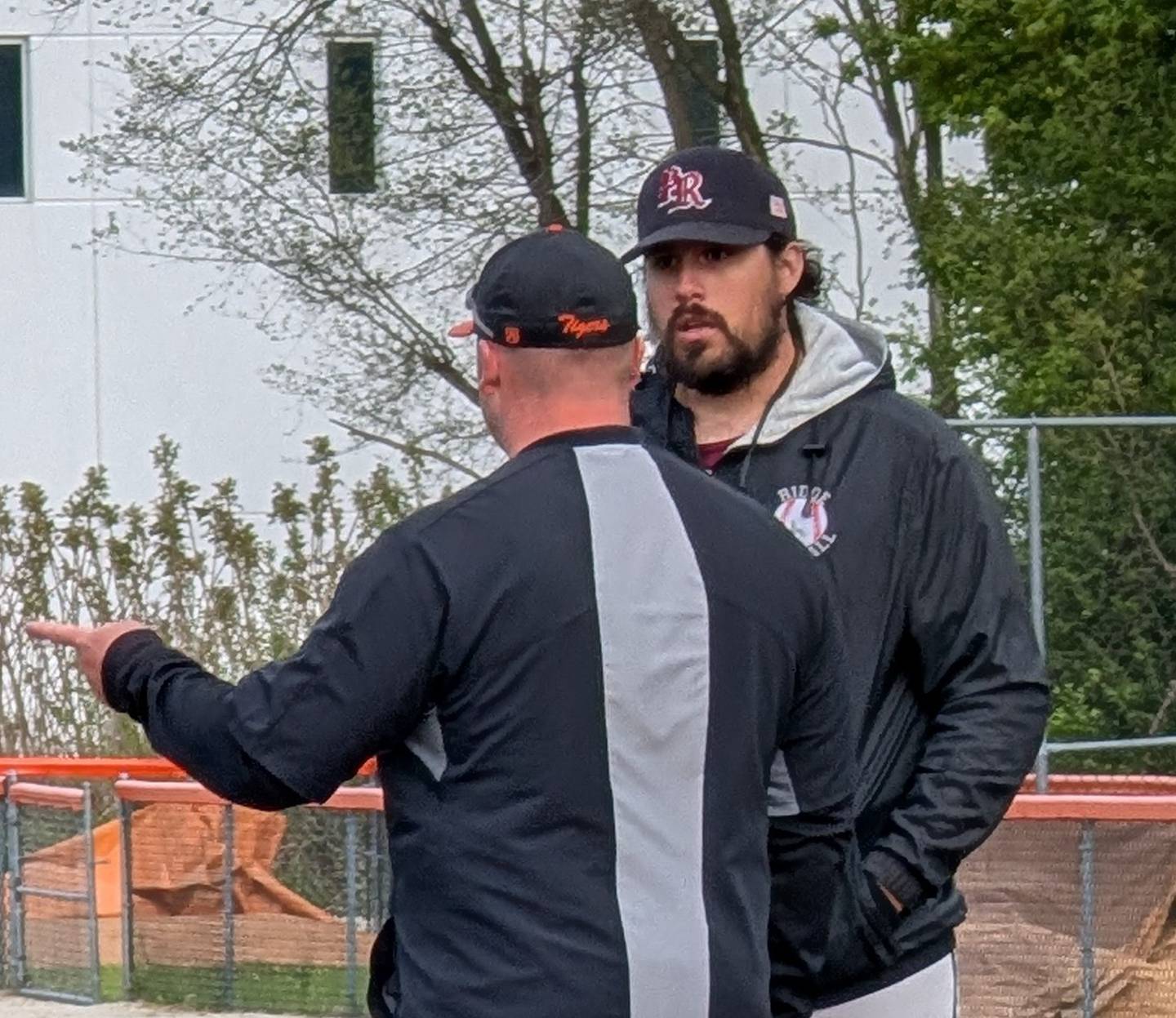 Prairie Ridge coach Austin Padjen (right) and Crystal Lake Central coach Cal Aldridge talk after their teams' Fox Valley Conference baseball game Wednesday, May 6, 2026, at Crystal Lake Central High School. Padjen served as Central's pitching coach the past five seasons.