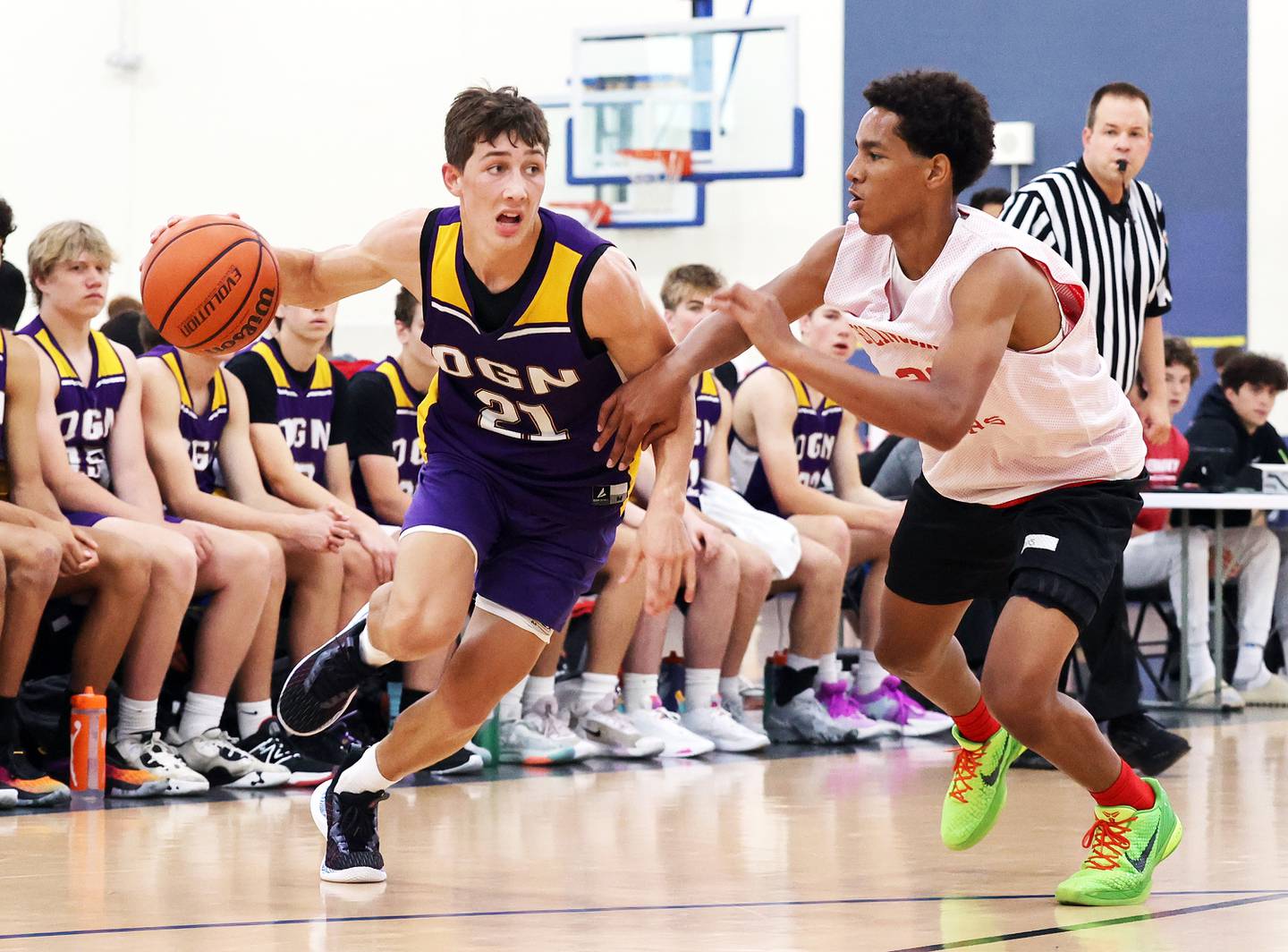 Downers Grove North's Jack Stanton (21) drives to the basket against Bolingbrook during the Riverside Brookfield Shootout for boys varsity basketball in Riverside on Friday, June 16, 2023.