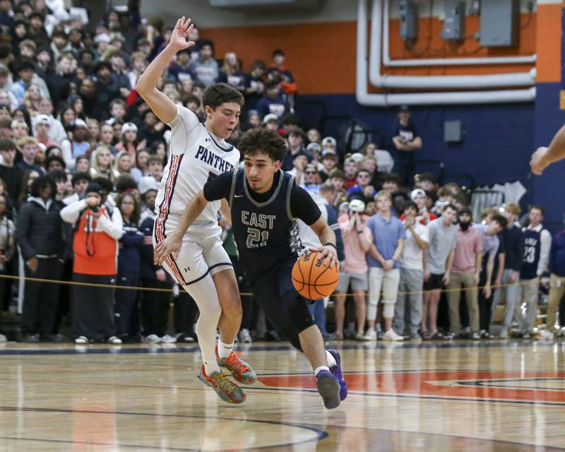 Oswego East's Juan Zavala (21) drives past the defense during their basketball game between Oswego East at Oswego Friday, Jan 09, 2025 in Oswego.