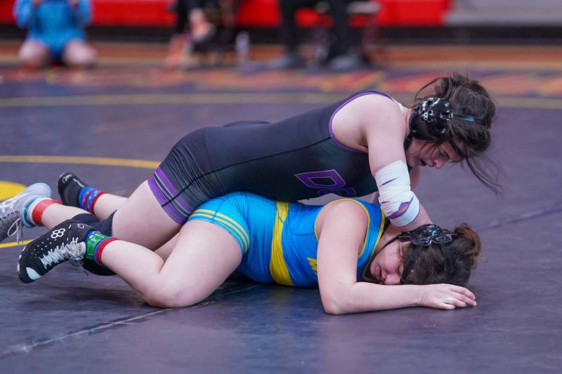 Downers Grove North’s Kayleigh Loo (top) competes against Maine West’s Lillian Garrett for the 170 pound championship in the Schaumburg Girls Wrestling Sectional at Schaumburg High School on Saturday, Feb 10, 2024.