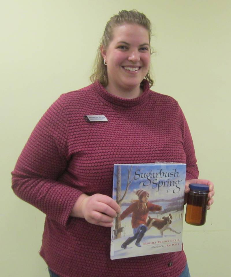 Marshall-Putnam extension service member, Catherine Girone, displays the book, "Sugarbush Spring" by Marsha W. Chall and a pint of maple syrup, used at her April 5 program for the Chief Senachwine Chapter NSDAR meeting. Girone also presents the program at schools for her Ag in the Classroom series for kindergarten through 12th grade students.