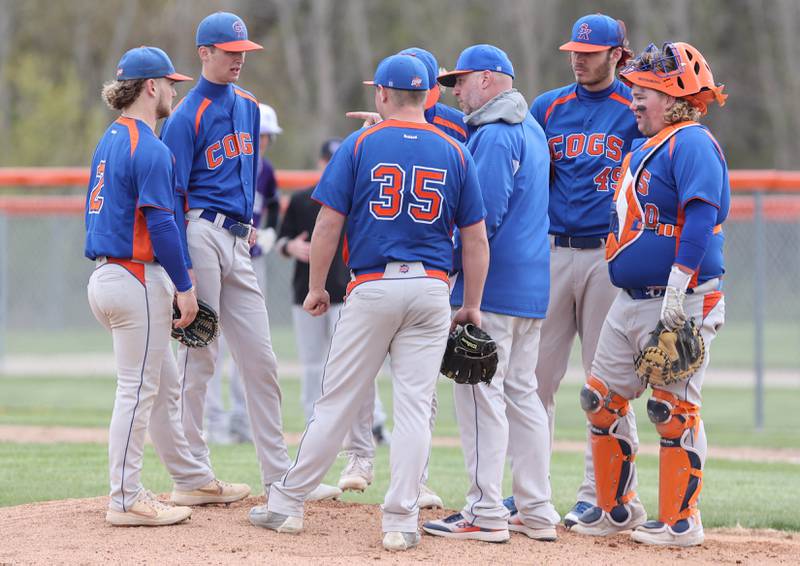 Genoa-Kingston players meet on the mound with their coach Roger Butler during their game against Rockford Lutheran Tuesday, May 2, 2023, at Genoa-Kingston High School.