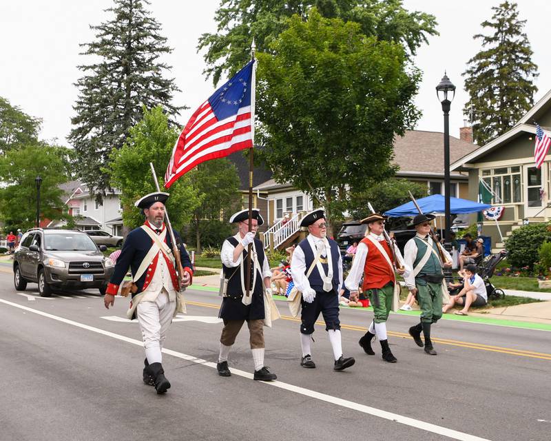 Sons of the American Revolution Fox Valley Chapter march during the Independence Day parade on Friday July 4, 2025, held in downtown Downers Grove.