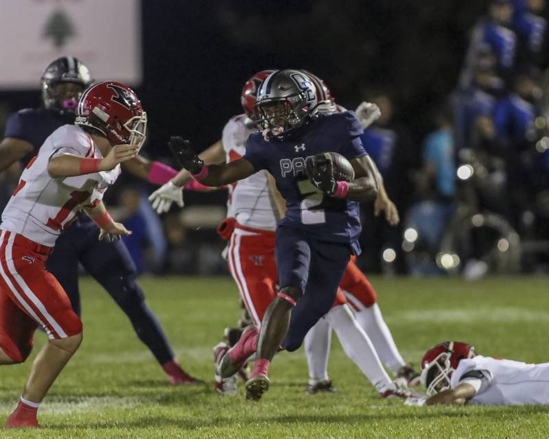 Oswego East's Jasiah Watson (2) fends off Yorkville's Brayden Brummel (21) during football game between Yorkville at Oswego East Friday, Oct 10, 2025 in Oswego.
