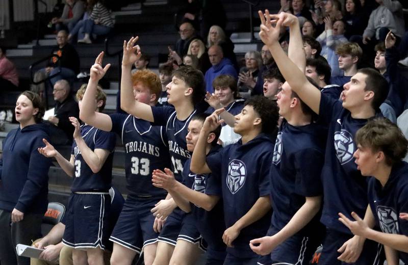 Cary-Grove’s Trojans celebrate a three-point basket in varsity boys basketball on Tuesday, Feb. 17, 2026, at McHenry High School in McHenry.