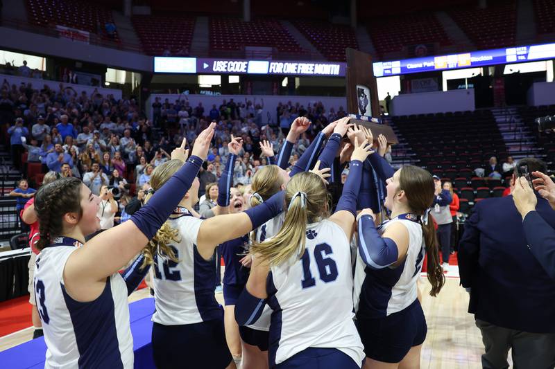 Cissna Park players hoist the IHSA Class 1A State championship trophy following the Timberwolves' victory in two sets, 25-11, 25-14, over Stockton on Saturday, Nov. 15, 2025.