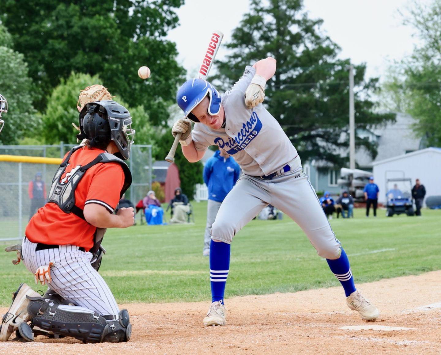 Princeton's Jace Stuckey takes one off the helmet in the sixth inning of Monday's 5-2 regional semifinal loss to Kewanee at Prather Field