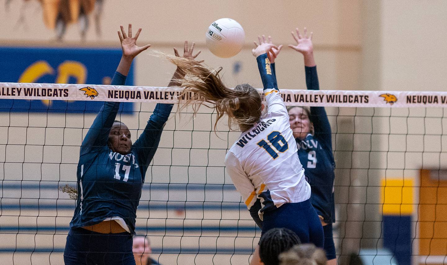Oswego East's Vivian Campbell (17) and Oswego East's Kylie Kany (9) defend the net against a kill attempt by Neuqua Valley's Eleanor O'Neal (16) during the Neuqua Valley 4A regional final volleyball match at Neuqua Valley High School in Naperville on Thursday, Oct 27, 2022.