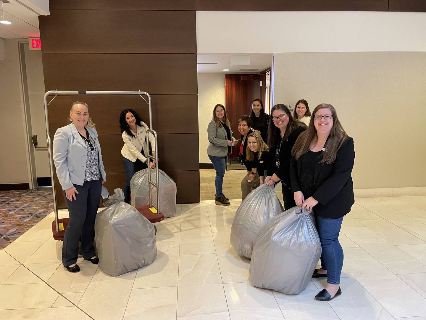 The Giving Door volunteers gather bags of presents purchased by shoppers for families and children in need.