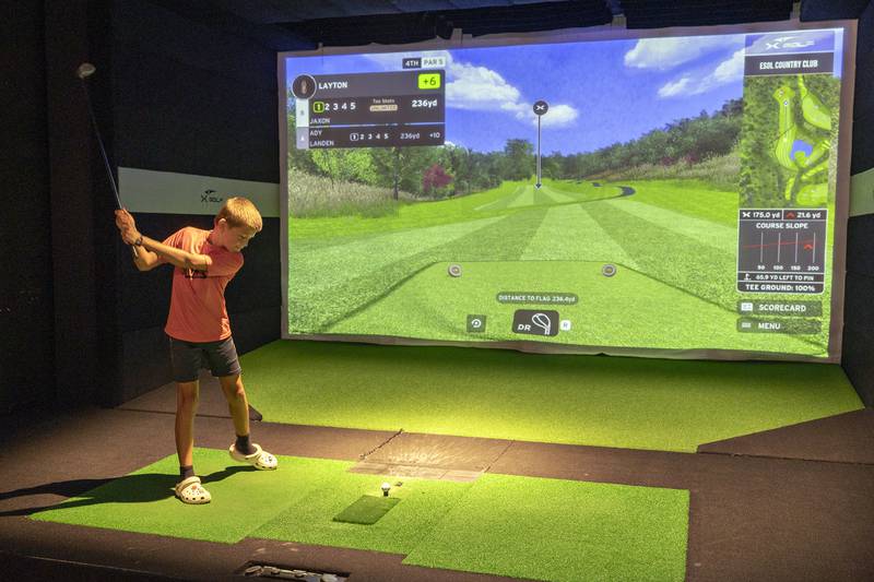Layton Rogers, 11, Milledgeville keeps his eye on the ball while playing at X-Golf Sauk Valley Thursday, August 7, 2025.