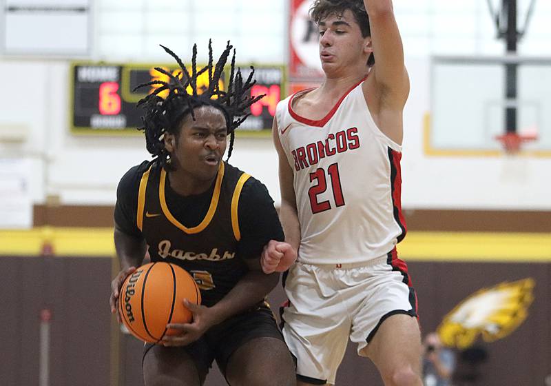 Jacobs’ Emaan Thomas looks past Barrington’s Gus Edstrom during Hinkle Holiday Classic varsity boys basketball tournament action on Monday, Dec. 23, 2024 at Jacobs High School in Algonquin.