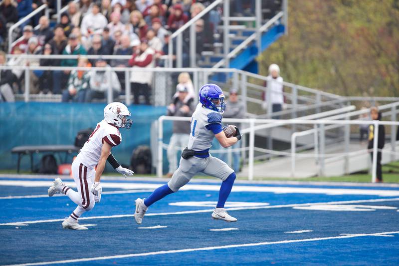 St. Francis Tanner Glock runs the ball for a gain against Prairie Ridge at the Class 5A second-round playoff game on Saturday Nov.9,2024 in Wheaton.