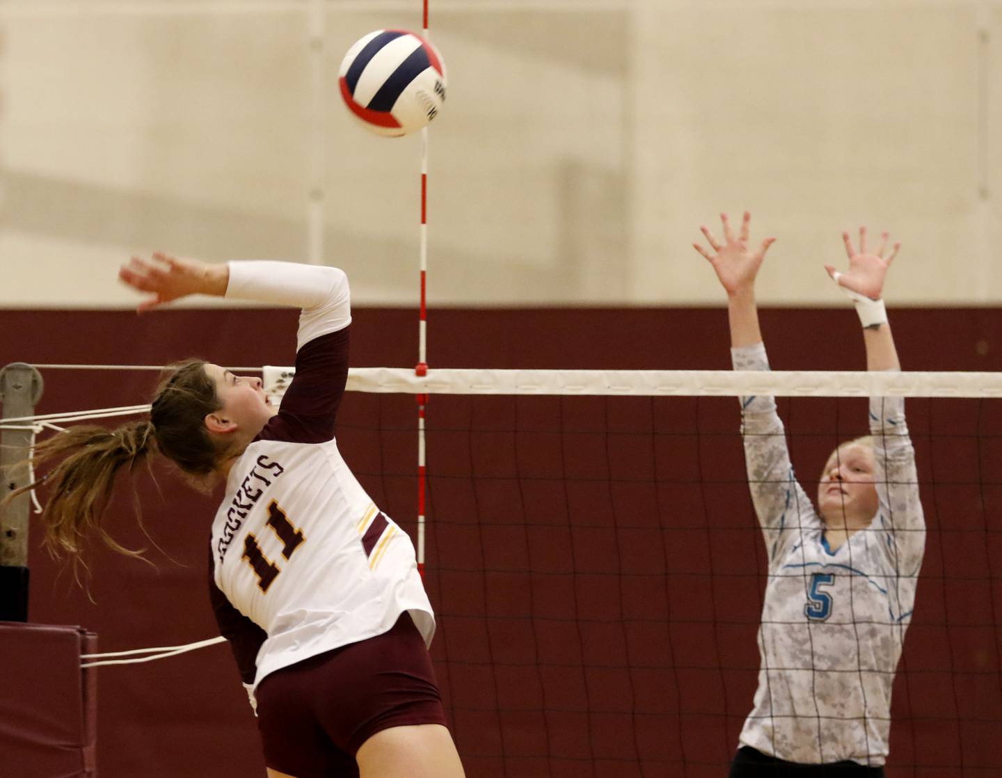 Richmond-Burton's Maggie Uhwat tries to spike the ball over the block of Woodstock North's Kylie Schulze during a Kishwaukee River Conference volleyball match Wednesday, Sept. 14, 2022, between Richmond-Burton and Woodstock North at Richmond-Burton Community High School.