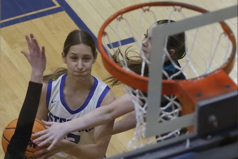 Woodstock's Victoria Cygan drives to the basket against Woodstock North's Adelyn Crabill during a Kishwaukee River Conference basketball game on Friday, Jan. 10, 2025, at Woodstock High School.