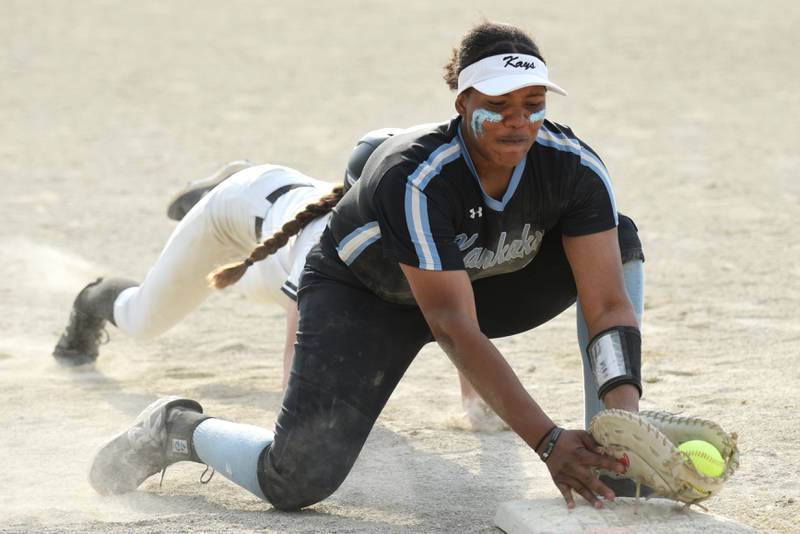 Kankakee's Kaleah Jackson fields a pickoff attempt at first base in front of a Bishop McNamara baserunner during a game at Bishop McNamara Tuesday, May 13, 2025.
