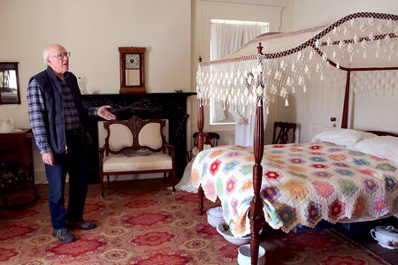 Putnam County Historical Society President Sidney Whittaker explains details of the master bedroom of the Pulsifer House in Hennepin.