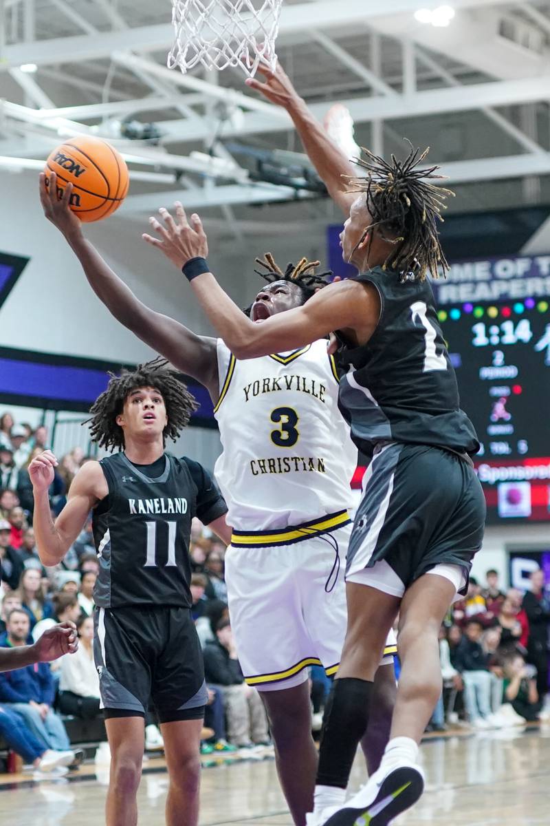 Yorkville Christian's Jayden Riley (3) drives to the hoop against Kaneland's Isaiah Gipson (2) during a championship final basketball game in the 61st annual Plano Christmas Classic at Plano High School on Saturday, December 28, 2024.
