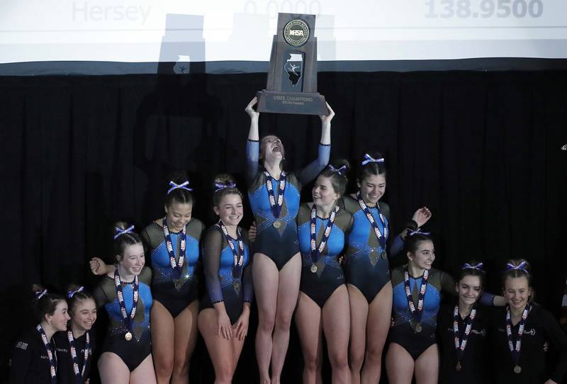 Downers Grove South celebrates their first place win at the IHSA Girls Gymnastics state finals Saturday February 18, 2023 in Palatine.