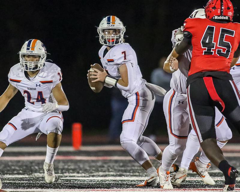 Oswego's Brett Connolly (7) drops back during a football game between Oswego at Bolingbrook on Friday, Oct 4th, 2024  in Bolingbrook.