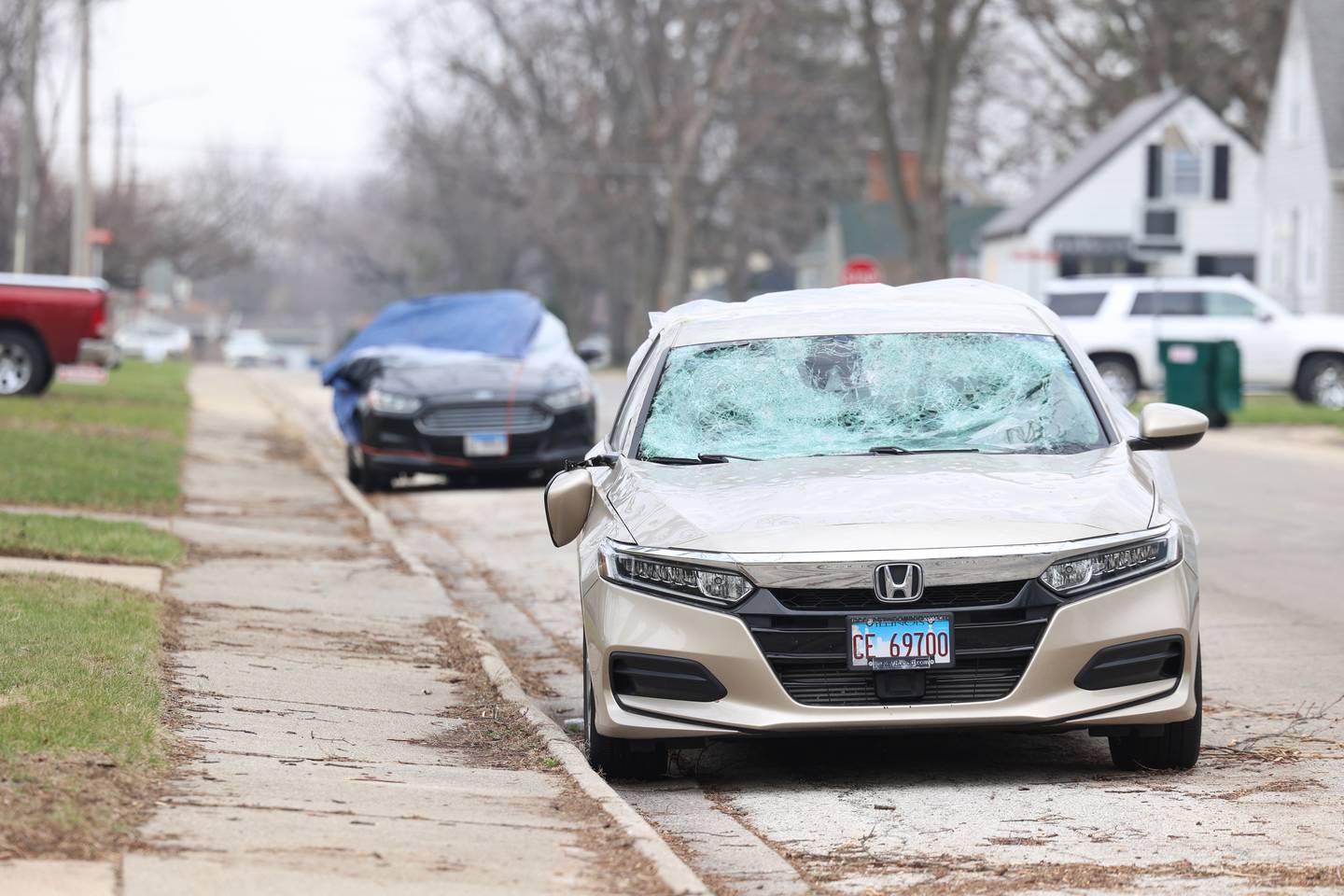 Damaged cars are parked and covered West Brookmont Boulevard in Bradley on March 26, 2026, following the March 10 storms that passed through Kankakee County.