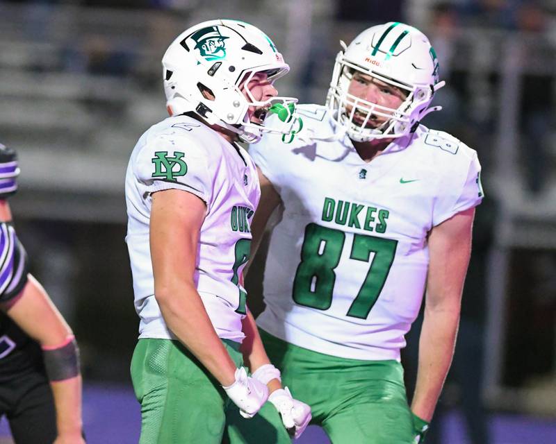 York's Anthony Massel, left,  celebrates after scoring a touchdown during the game while teammate Hunter Stephinach (87) joins in during the game on Friday Oct. 10, 2025, while traveling to take on Downers Grove North.