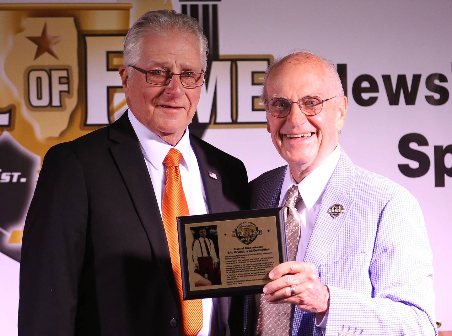 Eric Bryant receives his award from Lanny Slevin Emcee during the Shaw Media Illinois Valley Sports Hall of Fame on Thursday, June 8, 2023 at the Auditorium Ballroom in La Salle. Bryant was a legendary basketball coach at DePue and Hall High School where he won two straight Class A runner-up finishes in 1996-1997 and 1997-1998.