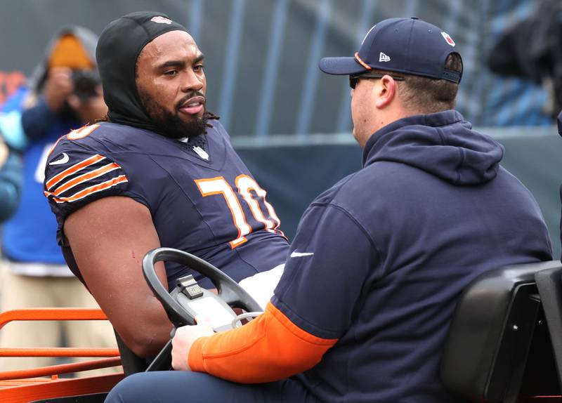 Chicago Bears offensive tackle Braxton Jones is carted off the field during their game Sunday, Dec. 22, 2024, at Soldier Field in Chicago.