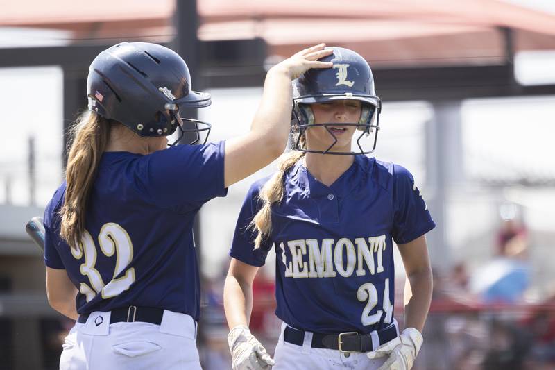Lemont’s Frankie Rita is congratulated by teammate Raegan Duncan after scoring against Benet Academy Friday, June 9, 2023 in the class 3A state softball semifinal.